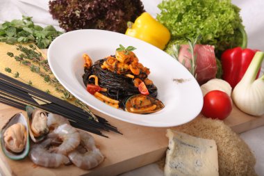 Black spaghetti with seafood on plate