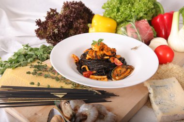 Black spaghetti with seafood on plate