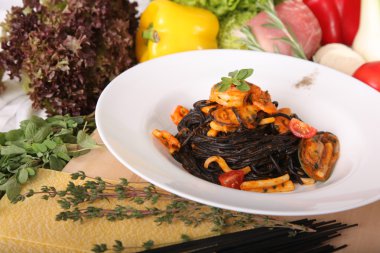 Black spaghetti with seafood on plate