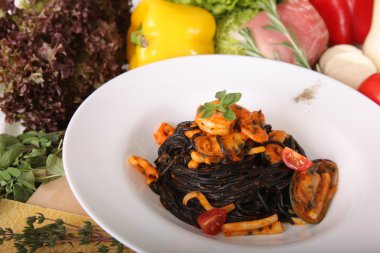 Black spaghetti with seafood on plate