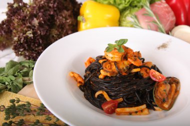 Black spaghetti with seafood on plate