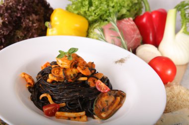 Black spaghetti with seafood on plate