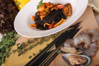Black spaghetti with seafood on plate