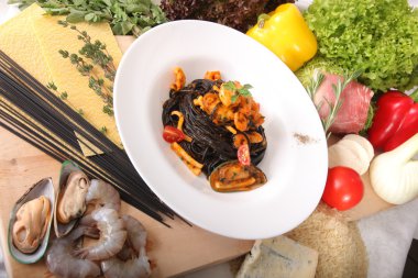Black spaghetti with seafood on plate