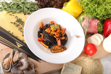 Black spaghetti with seafood on plate
