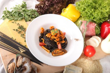 Black spaghetti with seafood on plate