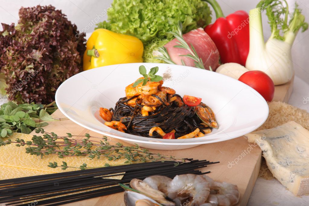 Black spaghetti with seafood on plate