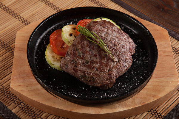 Steak flambe on hot black pan