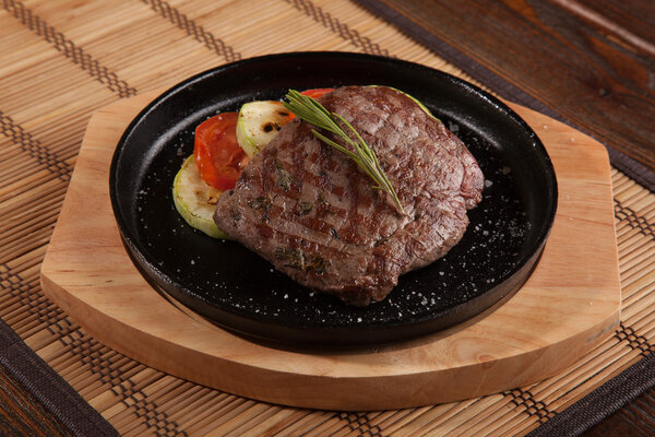 Steak flambe on hot black pan