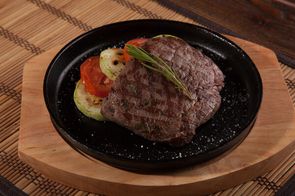 Steak flambe on hot black pan