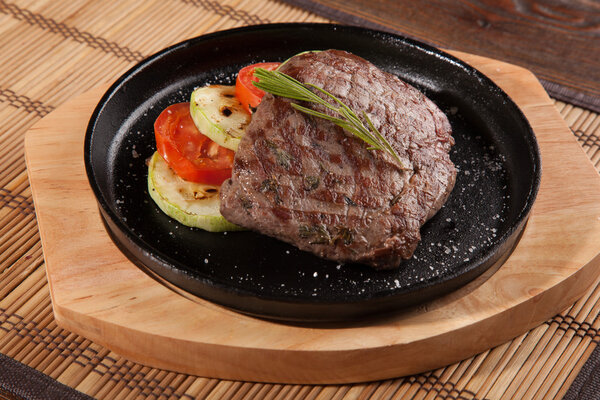 Steak flambe on hot black pan