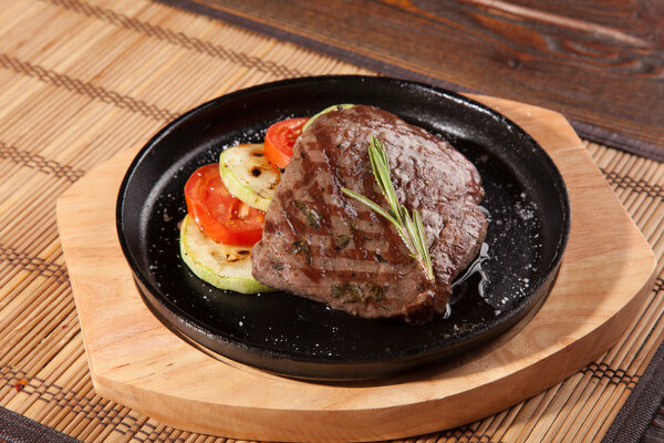 Steak flambe on hot black pan