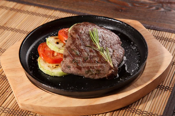 Steak flambe on hot black pan