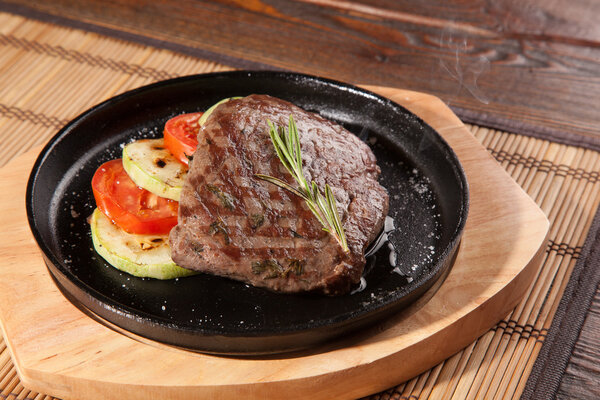 Steak flambe on hot black pan