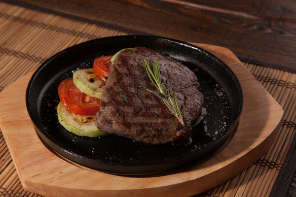 Steak flambe on hot black pan