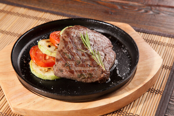 Steak flambe on hot black pan