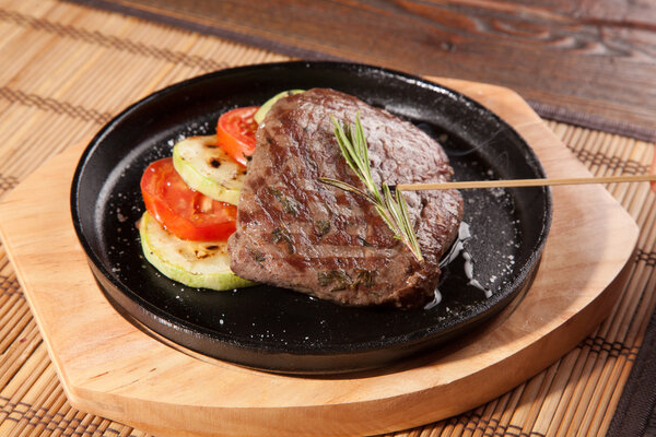 Steak flambe on hot black pan