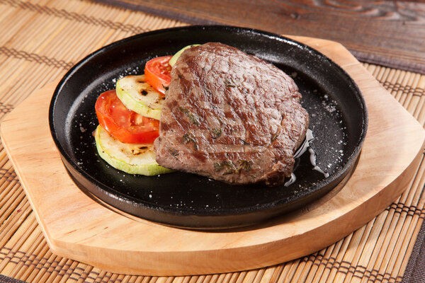 Steak flambe on hot black pan