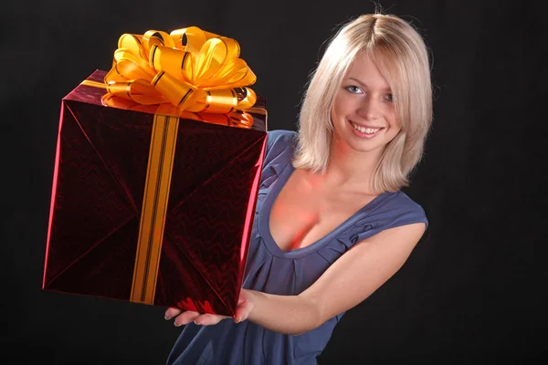 girl with a gift in the hands on black background