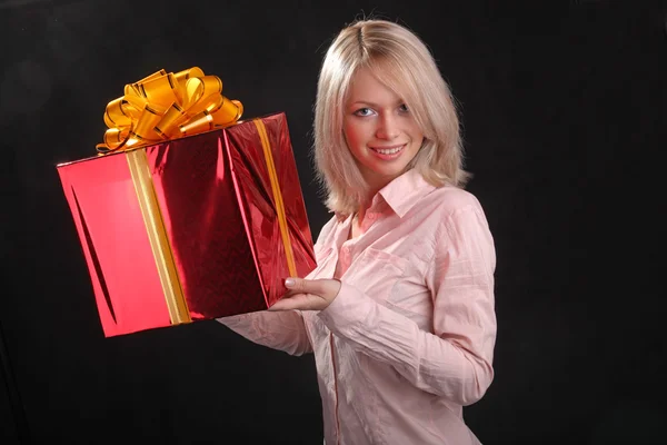blonde with a gift in the hands on black background