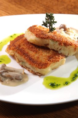 potato cutlets with mushroom sauce on plate