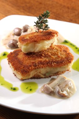 potato cutlets with mushroom sauce on plate