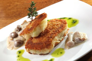 potato cutlets with mushroom sauce on plate