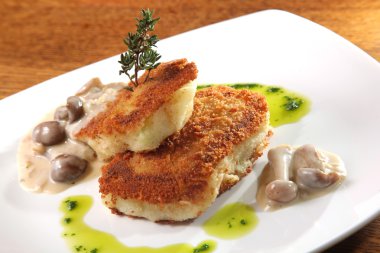 potato cutlets with mushroom sauce on plate