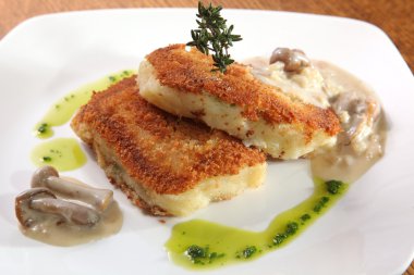 potato cutlets with mushroom sauce on plate