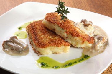 potato cutlets with mushroom sauce on plate