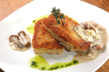 potato cutlets with mushroom sauce on plate