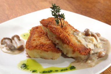 potato cutlets with mushroom sauce on plate