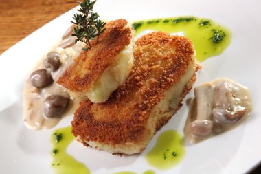 potato cutlets with mushroom sauce on plate