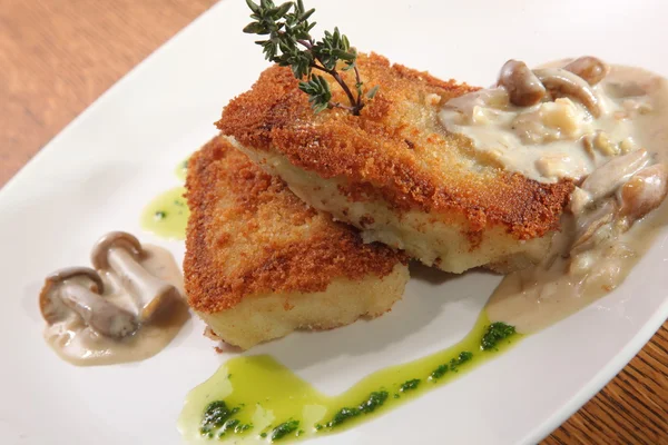 potato cutlets with mushroom sauce on plate
