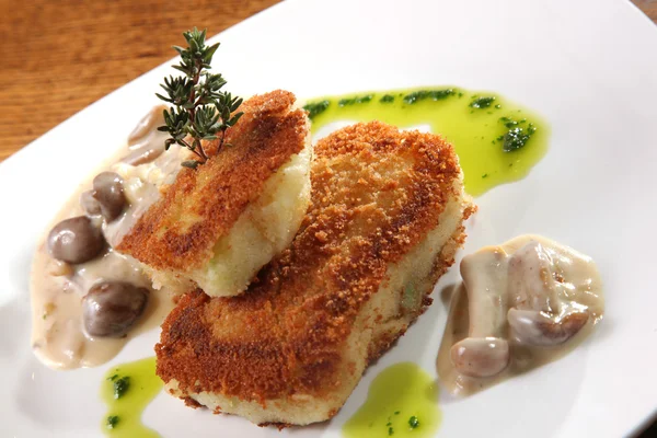 potato cutlets with mushroom sauce on plate