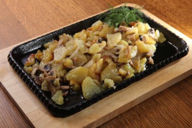 fried potatoes on a hot black frying pan