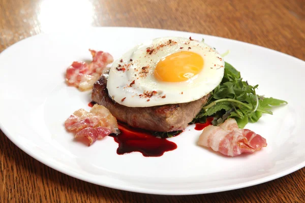 Kızarmış yumurta ve soslu biftek.