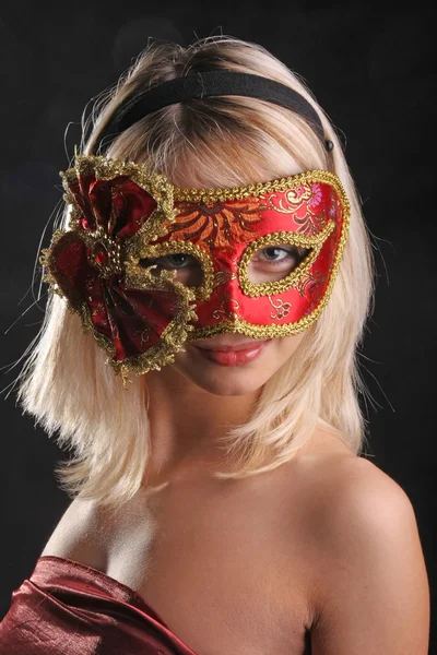 穿着威尼斯面具的金发美女在黑色背景下调情 — 图库照片