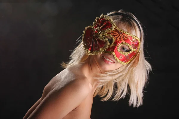 emotions on the face of the girl in the Venetian mask on black background