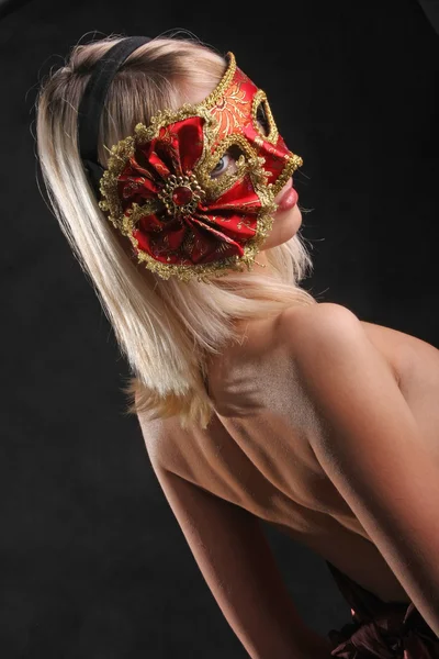 emotions on the face of the girl in the Venetian mask on black background