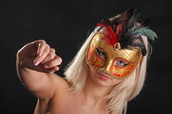 emotions on the face of the girl in the Venetian mask on black background