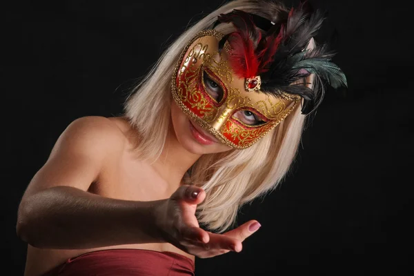 emotions on the face of the girl in the Venetian mask on black background