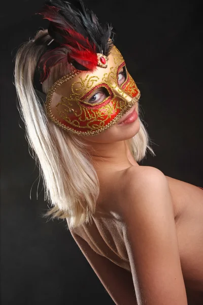 emotions on the face of the girl in the Venetian mask on black background