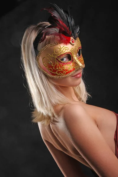 emotions on the face of the girl in the Venetian mask on black background