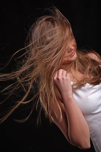 developing in the wind the hair on black background