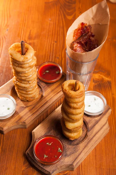 snacks to beer on a wooden table with sauce