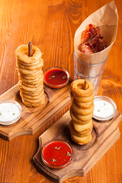snacks to beer on a wooden table with sauce