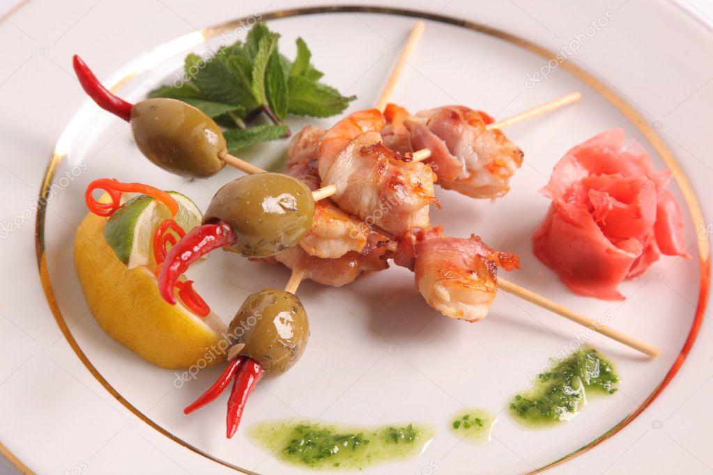 shrimp skewers with olives on plate