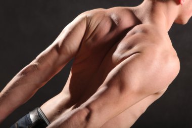 Çıplak erkek gövdesi ve siyah arka planda kas.