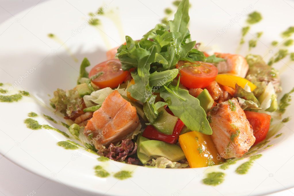 Salad with smoked salmon and vegetables and Arugula on plate